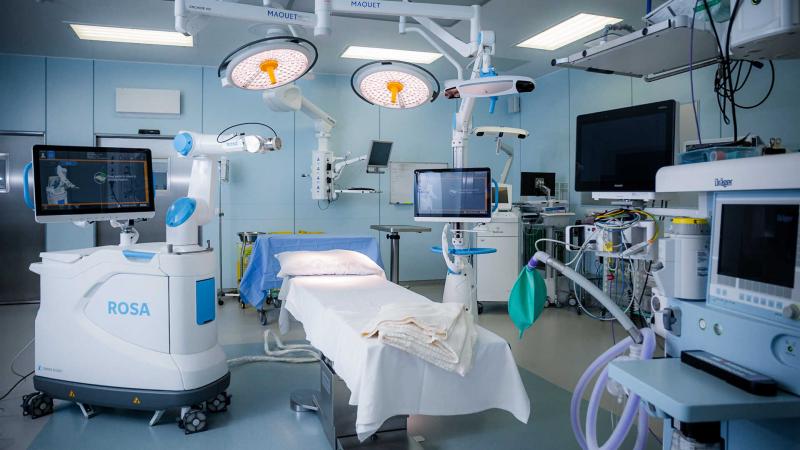 ROSA Knee System set up beside an operating table