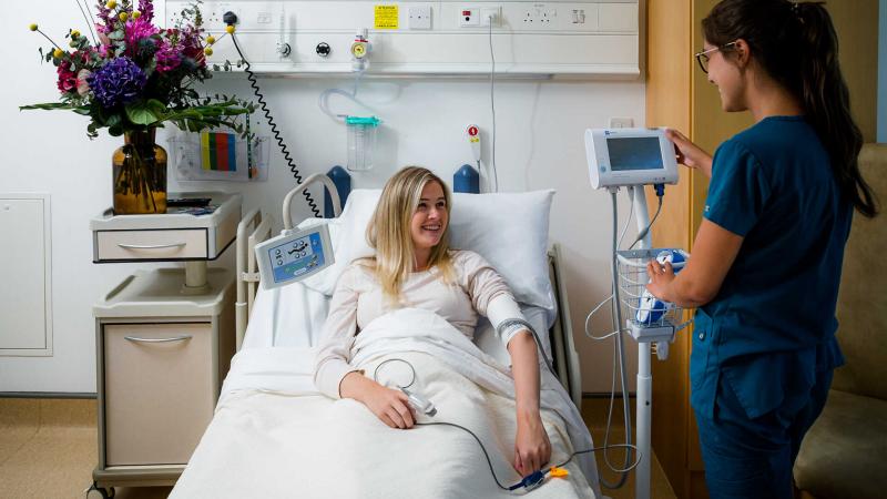 A nurse checking a patients blood pressure 