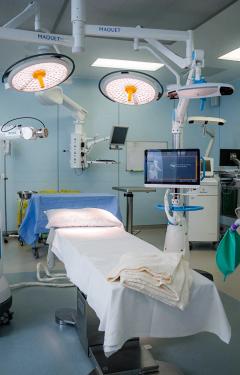Surgical operation room set up with equipment and operating table.